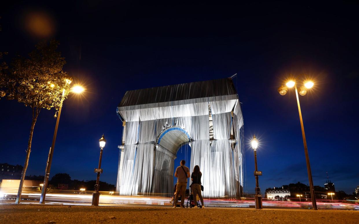 Arc De Triomphe in Paris is covered in silver-blue fabric as a tribute to the late artist Christo - YOAN VALAT/EPA-EFE/Shutterstock 