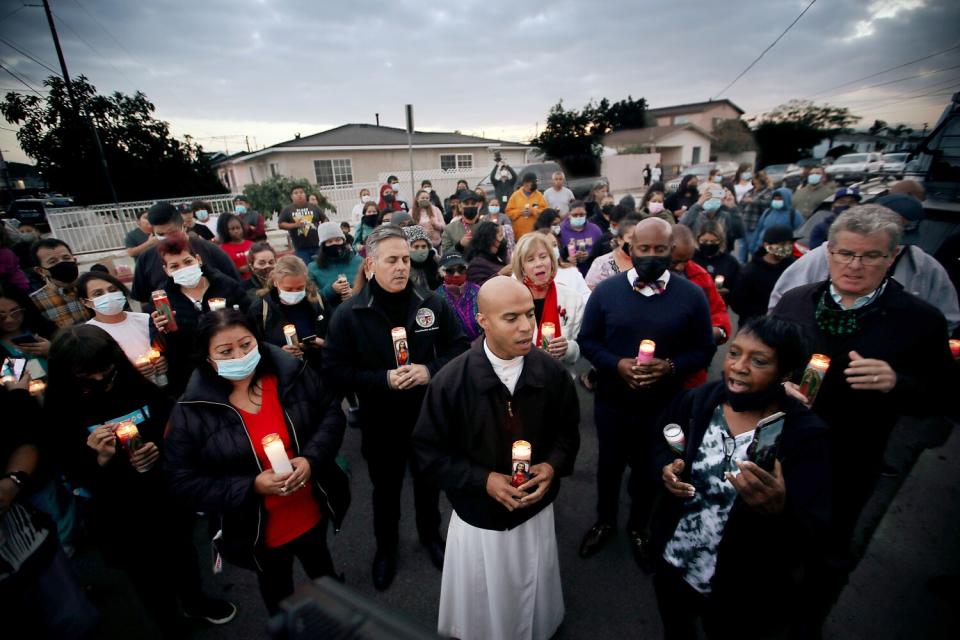 People hold candles outside