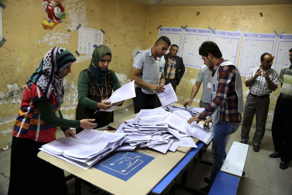 Electoral workers count ballots as polls close at a polling center in Baghdad, Iraq, Wednesday, April 30, 2014. Iraqis braved the threat of bombs and other violence to vote Wednesday in parliamentary elections amid a massive security operation as the country slides deeper into sectarian strife. (AP Photo/Karim Kadim)