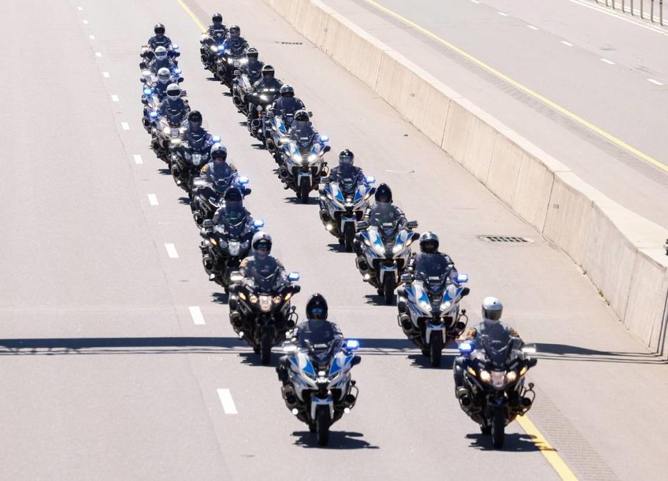 Scores of law enforcement form a processional for Deputy U.S. Marshal Thomas “Tommy” Weeks Jr. goes along Interstate 77 at exit 28 from Charlotte to Mooresville on Wednesday, May 1, 2024.