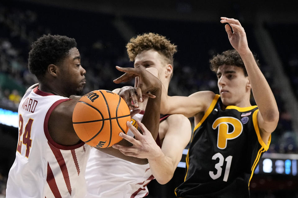 Iowa State forward Hason Ward, left, forward Aljaz Kunc vie for the ball with Pittsburgh forward Jorge Diaz Graham during the first half of a first-round college basketball game in the NCAA Tournament on Friday, March 17, 2023, in Greensboro, N.C. (AP Photo/Chris Carlson)