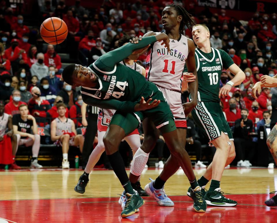 Michigan State forward Gabe Brown (44) vies for a rebound against Rutgers center Clifford Omoruyi (11) during the first half in Piscataway, N.J., Saturday, Feb. 5, 2022.