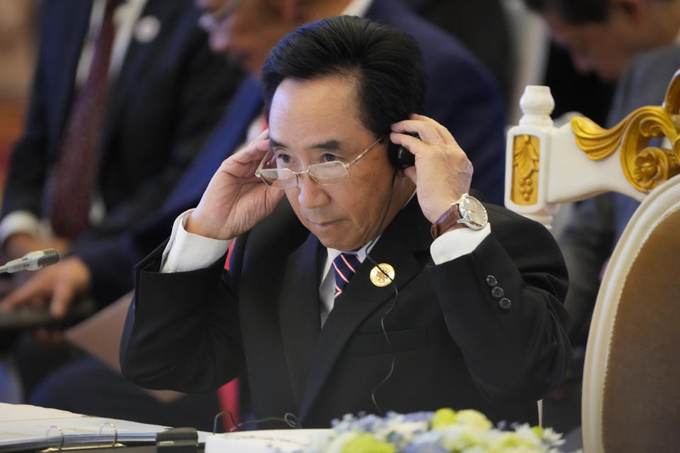 Laos Prime Minister Phankham Viphavanh adjusts his earphone while listening to South Korea's President Yoon Suk-yeol's speech during the ASEAN - South Korea Summits (Association of Southeast Asian Nations) in Phnom Penh, Cambodia, Friday, Nov. 11, 2022. The ASEAN summit kicks off a series of three top-level meetings in Asia, with the Group of 20 summit in Bali to follow and then the Asia Pacific Economic Cooperation forum in Bangkok. (AP Photo/Anupam Nath)