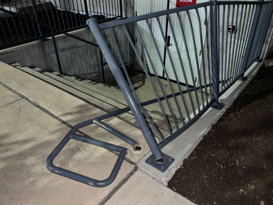 Damage to cars, street signs, etc. along East 9th Street near Embassy Drive after an 18-wheeler crashed into 10 parked vehicles overnight April 22, 2024 (KXAN Photo/Todd Bailey)