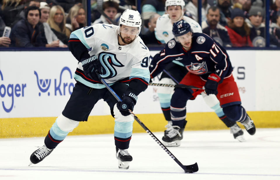 Seattle Kraken forward Tomas Tatar, left, controls the puck in front of Columbus Blue Jackets forward Justin Danforth during the first period NHL hockey game in Columbus, Ohio, Saturday, Jan. 13, 2024. (AP Photo/Paul Vernon)