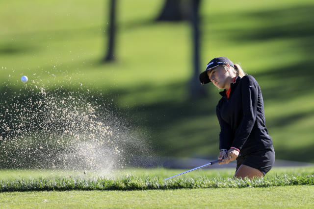 Gianna Clemente hits out of a bunker on the 11th green during the first round of the LPGA Tour Kroger Queen City Championship golf tournament in Cincinnati, Thursday, Sept. 8, 2022. (AP Photo/Aaron Doster)