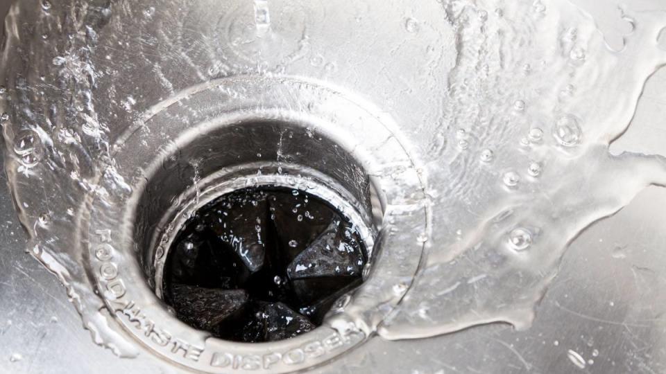 uses for ice cubes: Stainless steal kitchen sink with water drops