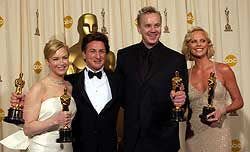 Charlize Theron, right, holds her Best Actress Oscar at the 2004 Academy Awards. She won for her work in "Monster," and was joined by fellow winners Renee Zellweger, Sean Penn and Tim Robbins.