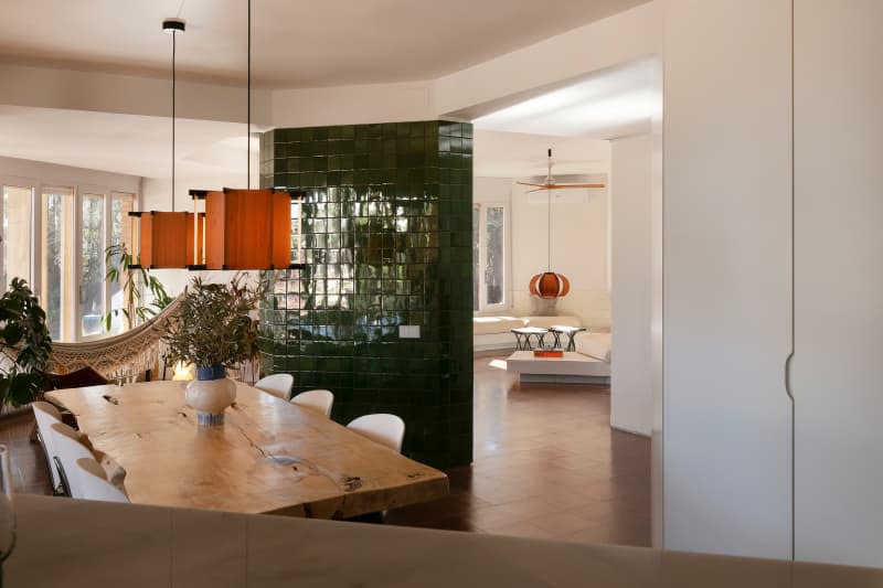 Pendants hanging over dining room table in open home.