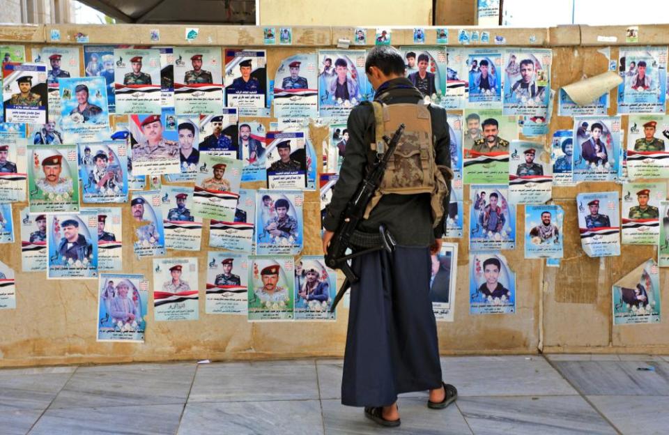 A Yemeni man attends the mass funeral of Houthi rebel fighters killed in battles with Saudi-backed government troops in the Marib region.