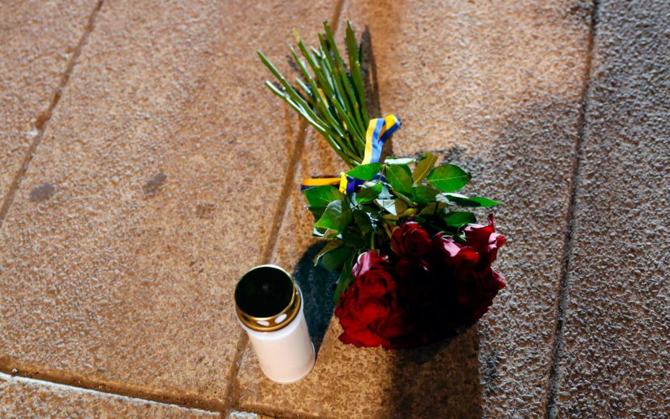 Flowers and a candle have been laid by Swedish Prime Minister Stefan Lofven - Credit: Odd Andersen/AFP