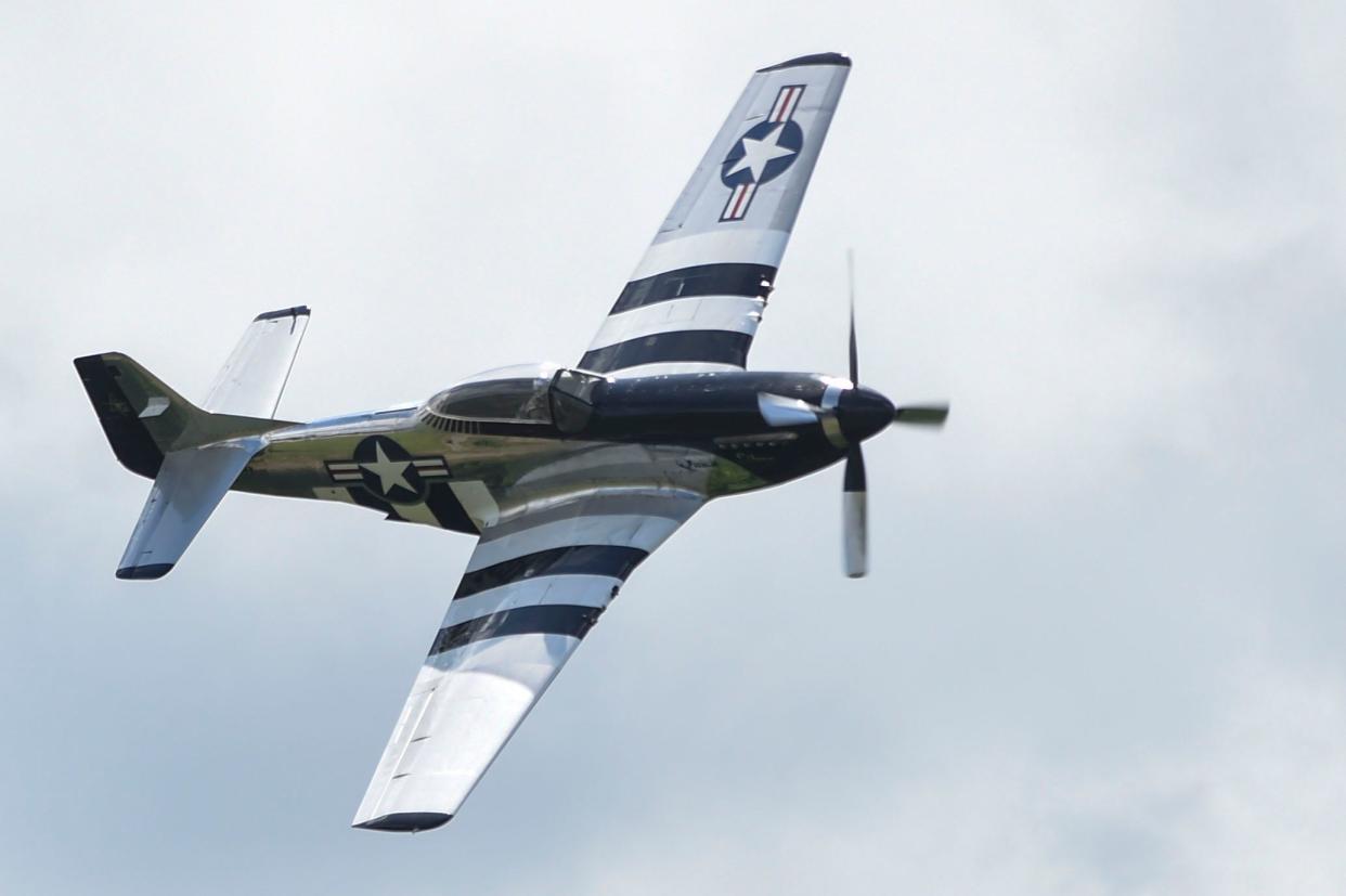 Scott Yoak flies a P-51 Mustang during the inaugural Augusta Air Show at the Augusta Regional Airport on Saturday. The P-51 is painted to honor branches of the U.S. armed forces.