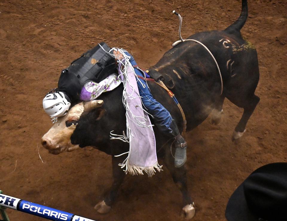 Stran Smith of Lantry, South Dakota slams his head on Piggly Wiggly during the Bull Riding competition at the San Angelo Rodeo Friday April 5, 2024. Smith was knocked unconscious but was revived and walked out of the arena.
