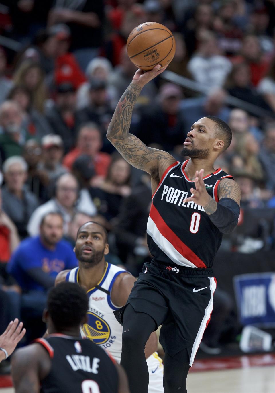 Portland Trail Blazers guard Damian Lillard, right, shoots against the Golden State Warriors during the second half of an NBA basketball game in Portland, Ore., Monday, Jan. 20, 2020. (AP Photo/Craig Mitchelldyer)