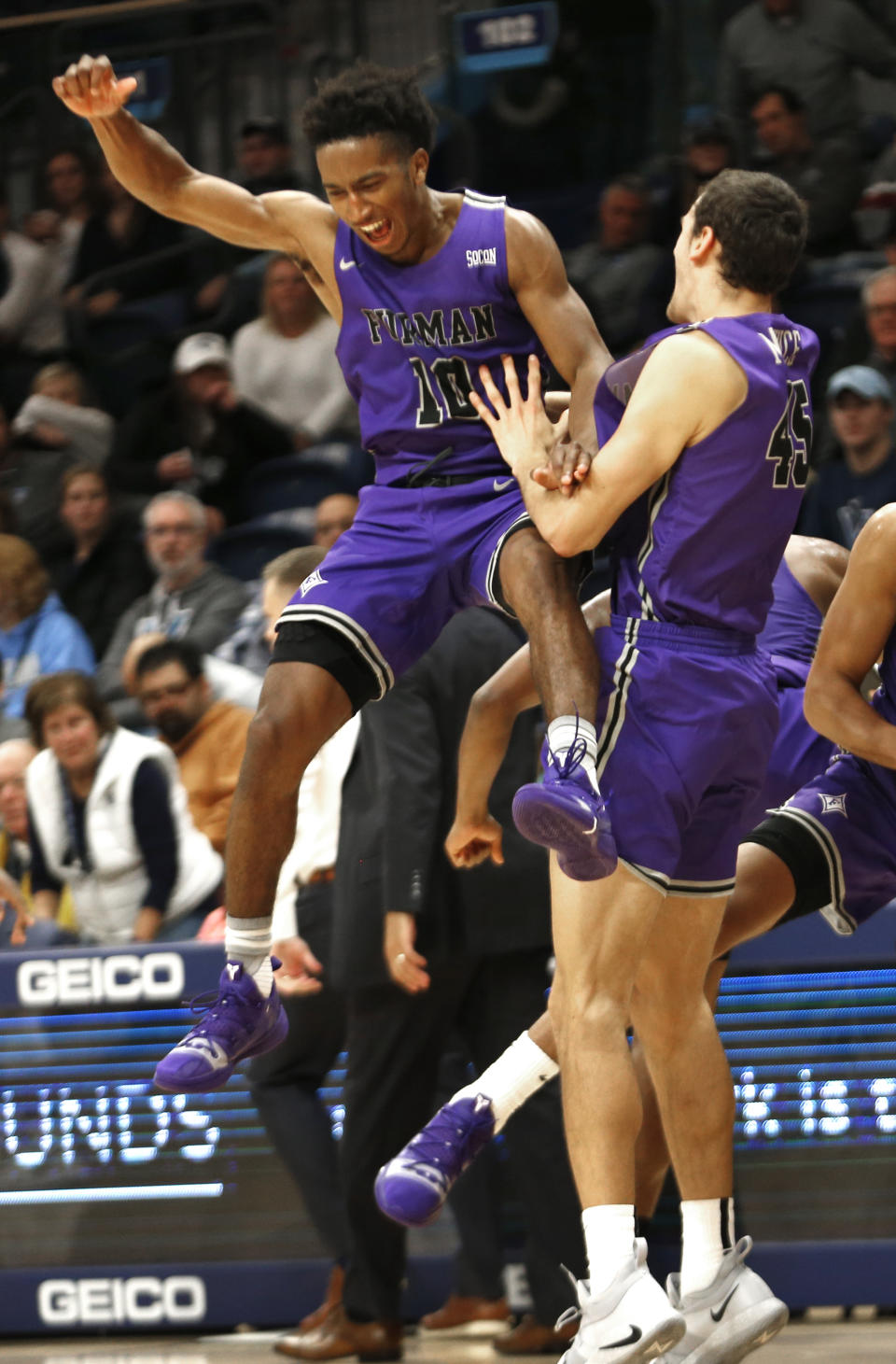 Furman guard Alex Hunter (10) and forward Clay Mounce (45) celebrate after their team defeated Villanova 76-68 in overtime in an NCAA college basketball game, Saturday, Nov. 17, 2018, in Villanova, Pa. (AP Photo/Laurence Kesterson)