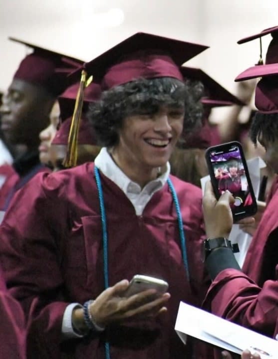 Gavin Guffey in a graduation gown