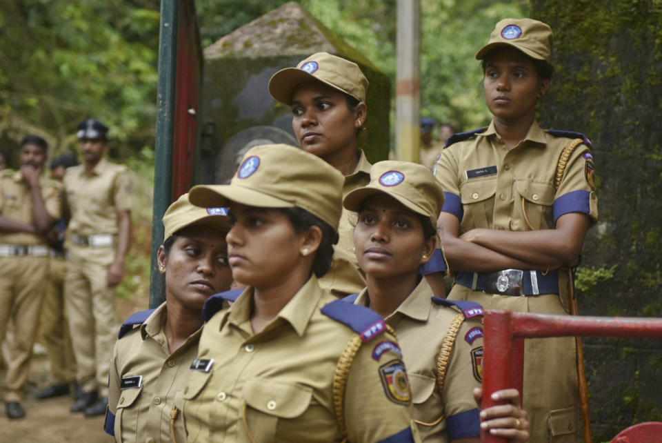 Women police personnel are deployed to guard against protestors blocking the path of women of menstruating age going to the Sabarimala temple at Nilackal, a base camp on way to the mountain shrine in Kerala, India, Wednesday, Oct. 17, 2018. The historic mountain shrine, one of the largest Hindu pilgrimage centers in the world is set to open its doors to females of menstruating age following a ruling by the country's top court. Police arrested some protesters when they tried to block the path of some females. (AP Photo)
