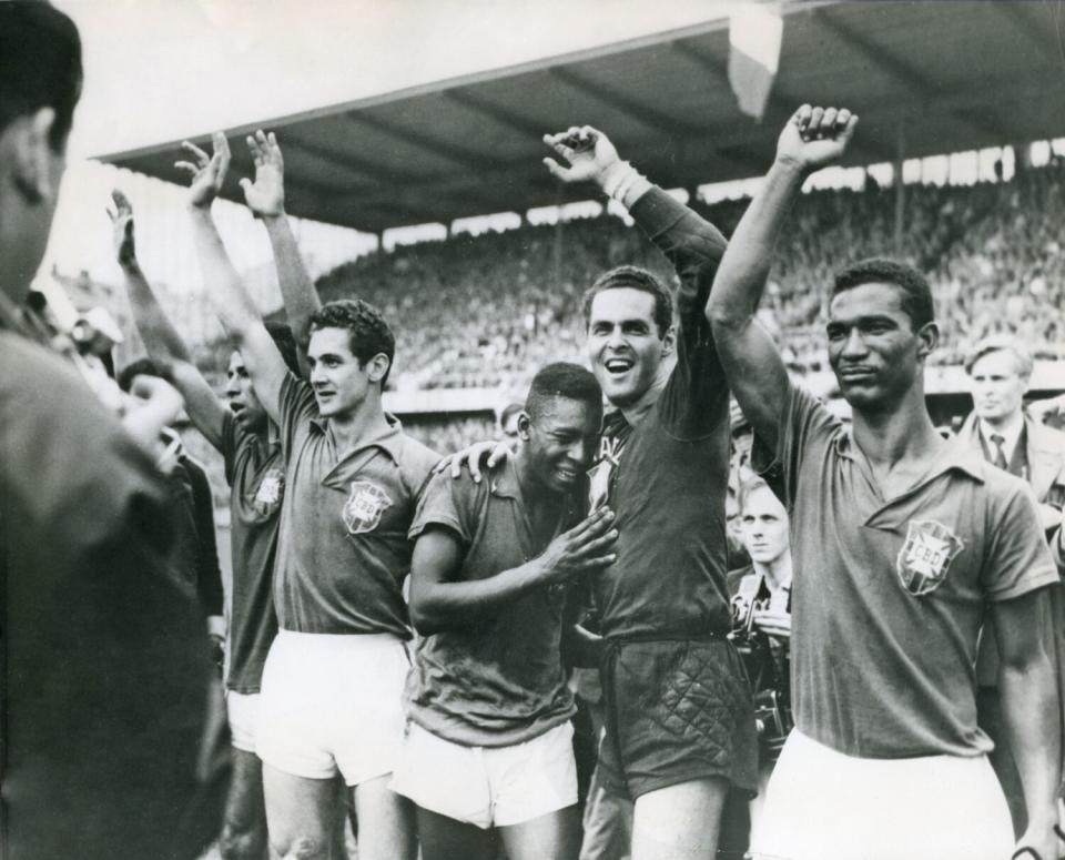 Pele, center, weeps on the shoulder of goalkeeper Gylmar Dos Santos Neves after Brazil's 1958 World Cup victory.