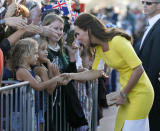 FILE - This is a Wednesday, April 16, 2014 file photo of Britain's Kate, the Duchess of Cambridge, as she meets with people on the steps of the Sydney Opera House following a reception in Sydney, Australia. Kate’s dilemma: What to pack for a two-week trip, when your itinerary includes everything from state receptions and church services to toddler playdates and cricket games? For the Duchess of Cambridge, who’s rounding up her trip to Australia and New Zealand with husband Prince William and 8-month-old son George, there were additional sartorial dilemmas: Do royals take off their shoes at the beach? And what’s the most ladylike way to climb into a fighter jet while in a pencil dress and high heels? (AP Photo/Jason Reed, Pool, File)