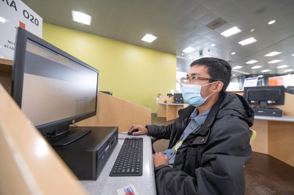 Arun Meng uses one of the computer stations at the Rawlings Public Library in this Chieftain file photo from 2020.