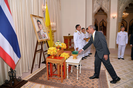 Craig Challen, Australian member of the Thai cave rescue team receives the Member of the Most Admirable Order of the Direkgunabhorn award in front of a portrait of Thailand's King Maha Vajiralongkorn at the Government House in Bangkok, Thailand, April 19, 2019. Thailand Government House/Handout via REUTERS