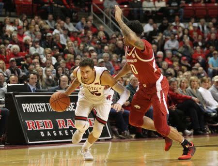 Jan 26, 2019; Lubbock, TX, USA; Texas Tech Red Raiders guard Davide Moretti (25) drives the ball around Arkansas Razorbacks guard Desi Sillis (0) in the first half at United Supermarkets Arena. Mandatory Credit: Michael C. Johnson-USA TODAY Sports