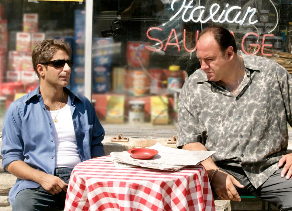 This undated image released by HBO shows Michael Imperioli, left, and James Gandolfini in a scene from "The Sopranos." The TV show is celebrating the 25th anniversary of its premiere. The six-season show would win 21 Emmys and become the first cable series ever to win the Emmy for outstanding drama series. (HBO via AP)