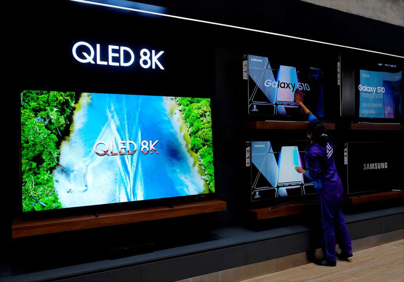 FILE PHOTO: A worker cleans a TV screen at the Samsung store in La Paz