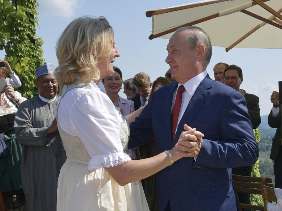 FILE - Russian President Vladimir Putin, right, dances with then Austrian Foreign Minister Karin Kneissl as he attends the wedding of Kneissl with Austrian businessman Wolfgang Meilinger in Gamlitz, southern Austria, Saturday, Aug. 18, 2018. Kneissl has announced on Telegram on Wednesday, Sept. 13, 2023, she has moved to Russia to work for a think tank she has set up in St. Petersburg. (Alexei Druzhinin, Sputnik, Kremlin Pool Photo via AP, File)