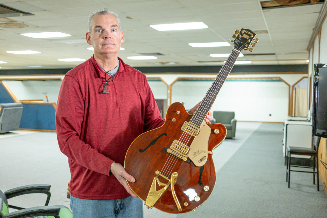 J.D. Northcutt, co-owner, shows his father's guitar April 4 ahead of the closure of Jude ’n’ Jody & Sons Furniture in Oklahoma City.