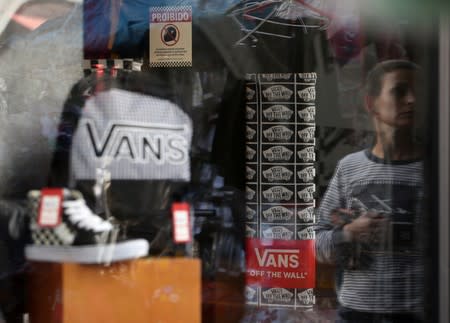 Shoes and backpack of Vans are seen in a shop window in Sao Paulo