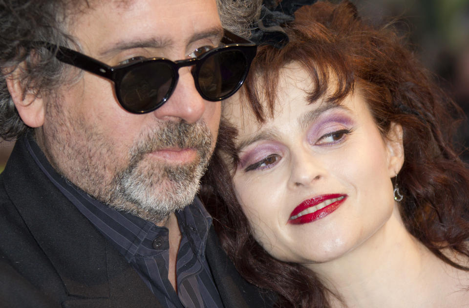 FILE This Wednesday, May 9, 2012 file photo shows film director Tim Burton and wife Helena Bonham Carter as they arrive for the UK Premiere of 'Dark Shadows', at a central London cinema. Britain's biggest film showcase opens Wednesday Oct. 10, 2012 with the European premiere of London-based American director Tim Burton's "Frankenweenie," the animated tale of a boy and his beloved _ but dead _ dog. It ends Oct. 21 with Mike Newell's adaptation of Charles Dickens' "Great Expectations," which stars Burton's real-life partner, Helena Bonham Carter, as haunted Miss Havisham. Festival director Clare Stewart said she was happy to be "bracketing the festival with one of London's great love affairs" _ the ghoul-loving filmmaker and his gothic muse. (AP Photo/Joel Ryan)