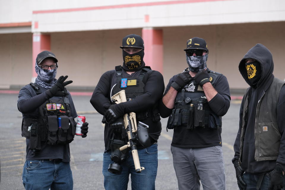 Members of the far-right group Proud Boys gather for a rally in an abandoned parking lot on the outskirts of town on Sunday, Aug. 22, 2021, in Portland, Ore. (AP Photo/Alex Milan Tracy)