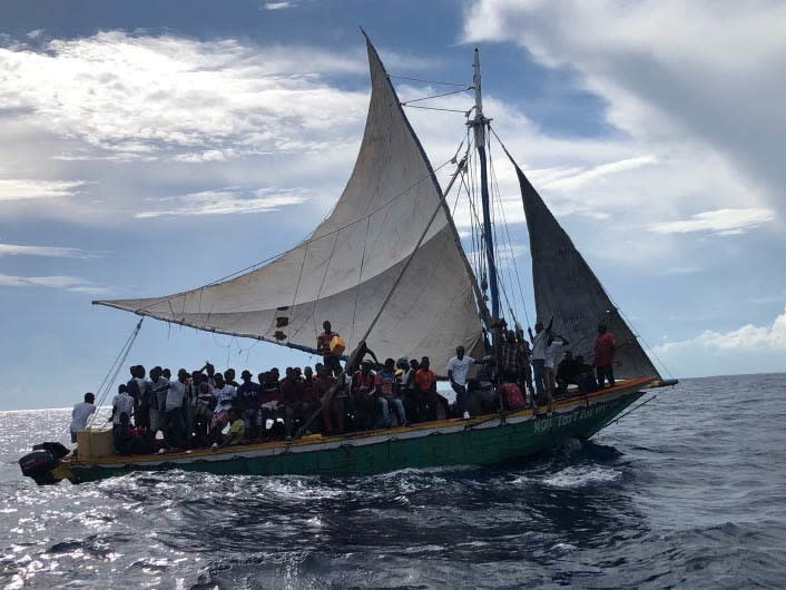 Migrants aboard a 35-foot sailing vessel are interdicted by a U.S. Coast Guard crew approximately 12 miles east of Biscayne Bay off Florida on Sept. 16. 