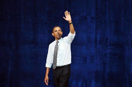 US President Barack Obama waves after speaking at a campaign fundraiser September 25, at the Paramount Theater in Seattle, Washington. Europe's failure to tackle crippling Greek debt is "scaring the world," Obama warned as Germany stoked fears Tuesday of a worldwide plunge back into recession