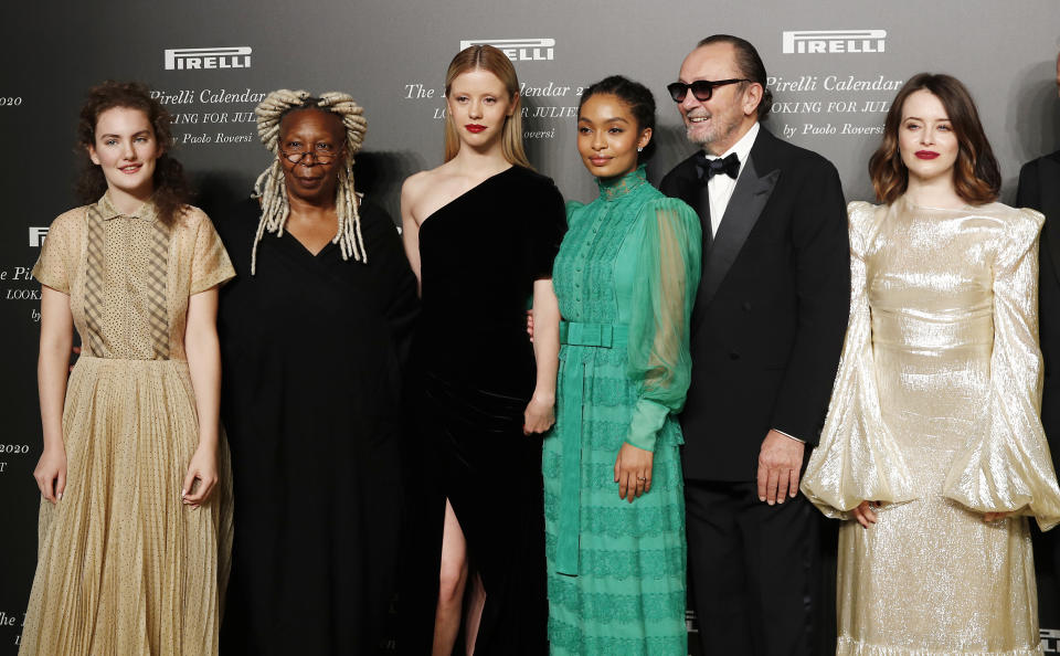 From left, Stella Roversi, American actress Whoopi Goldberg, British model Mia Goth, American model Yara Shahidi, Italian photographer Paolo Roversi and British actress Claire Foy pose for photographers at the 2020 Pirelli Calendar event in Verona, Italy, Tuesday, Dec. 3, 2019. (AP Photo/Antonio Calanni)