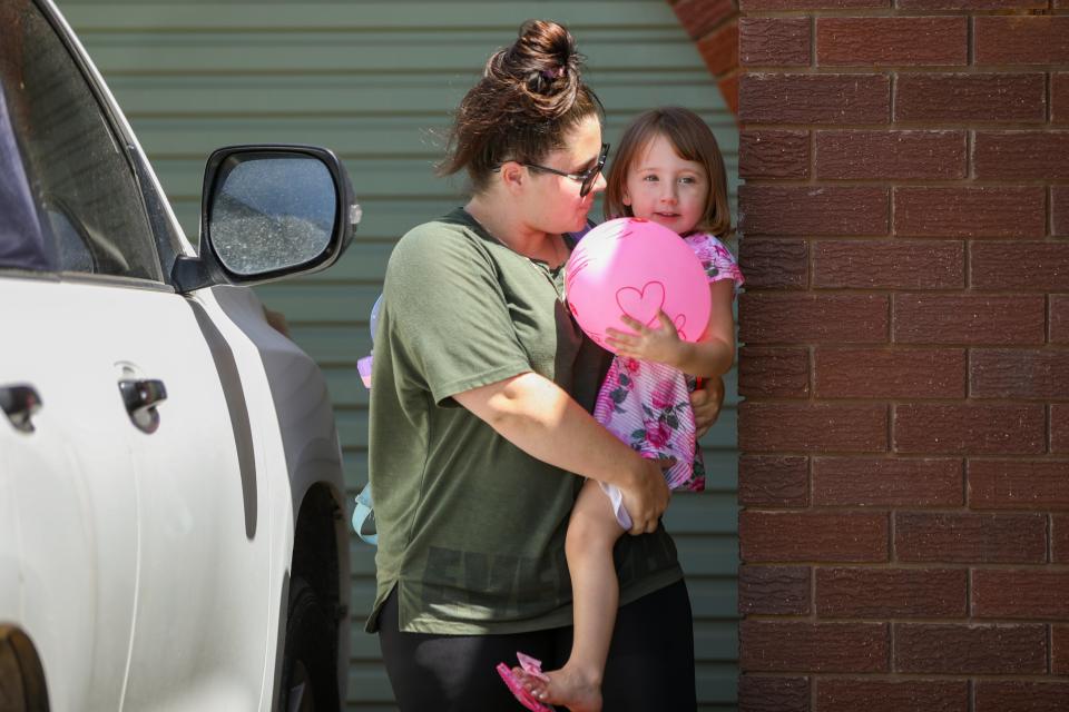 Cleo Smith is carried inside a friend's house by her mother on 4 November 2021 in Carnarvon, Australia (Getty Images)