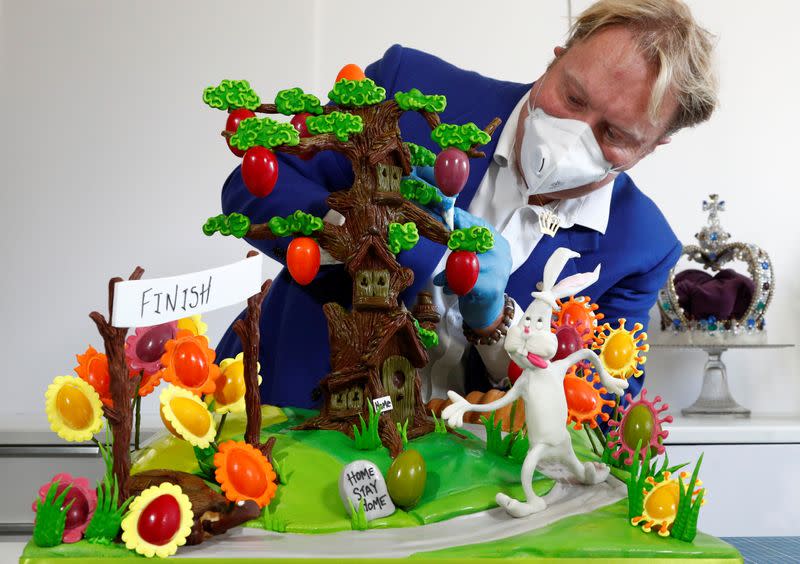 Cake maker Lewis-Anderson puts the finishing touches to a scene with chocolate tree and Easter eggs in La Hulpe