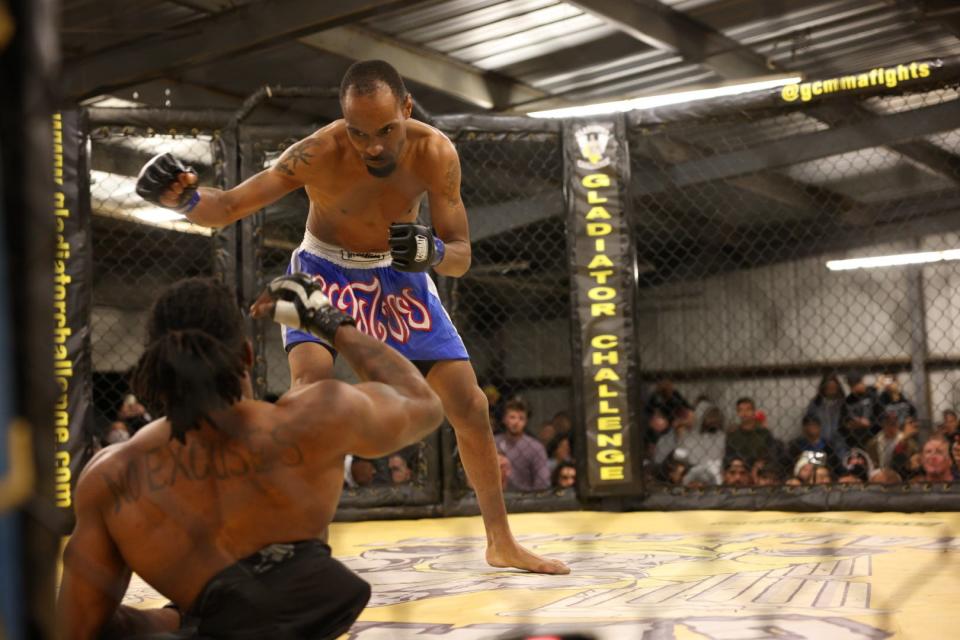 Zion Clark, from rear, is shown fighting in an mixed martial arts match in 2022. Born without legs, the former Massillon resident won the fight and is planning a second match.