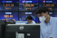 A currency trader watches monitors at the foreign exchange dealing room of the KEB Hana Bank headquarters in Seoul, South Korea, Friday, Oct. 15, 2021. Asian shares were higher Friday after technology companies powered the biggest gain on Wall Street since March. (AP Photo/Ahn Young-joon)