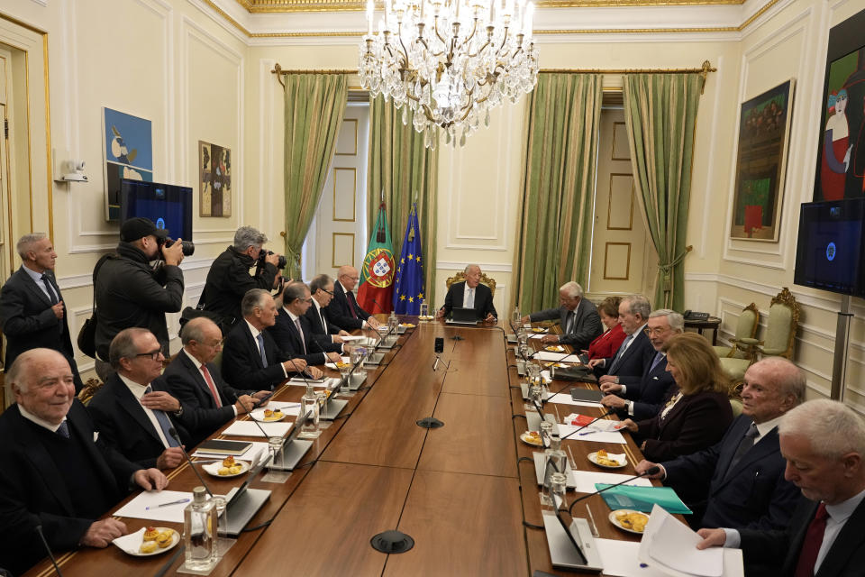 Portuguese President Marcelo Rebelo de Sousa, center, speaks to outgoing Prime Minister Antonio Costa , at his left, during the State Council meeting called by the president at the Belem presidential palace in Lisbon, Thursday, Nov. 9, 2023. On Tuesday, Prime Minister Costa resigned while his government is involved in a widespread corruption probe. After the council meeting, Rebelo de Sousa is expected to announce if he will call early elections or try to appoint a new prime minister. (AP Photo/Armando Franca)