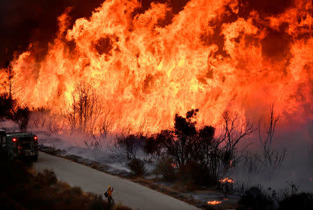 Fire fighters attack the Thomas Fire’s north flank with backfires as they continue to fight a massive wildfire north of Los Angeles, near Ojai, California. REUTERS/Gene Blevins