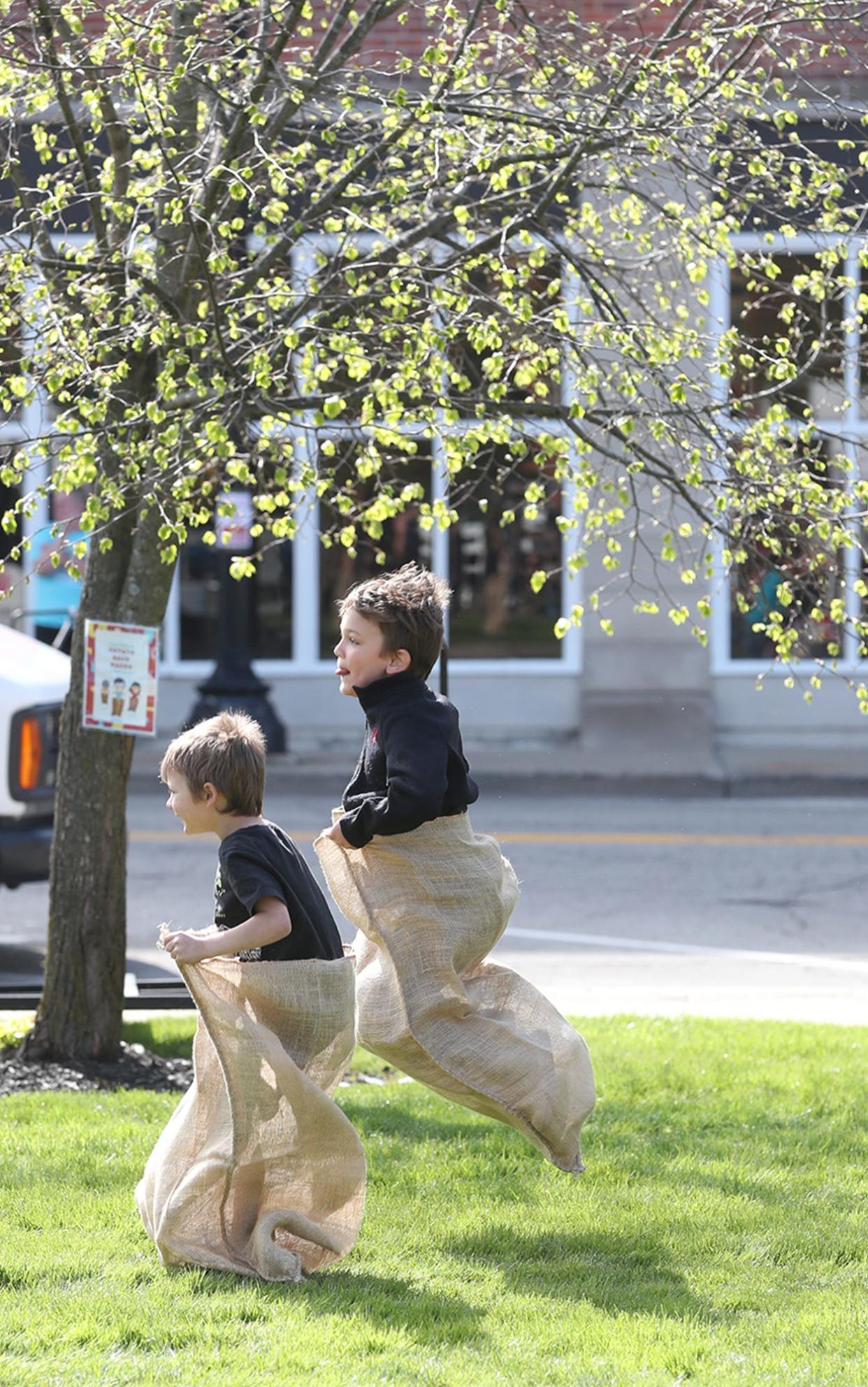 Jackson Lloyd, 4, and his brother Quentin, 6, take part in a potato sack race at the Ravenna Jo-Jo Fest Friday.