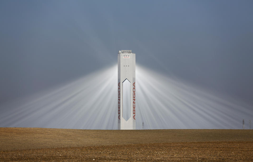 Rays of light stream from a tower of the Solucar solar park in Sanlucar la Mayor, near Seville. 