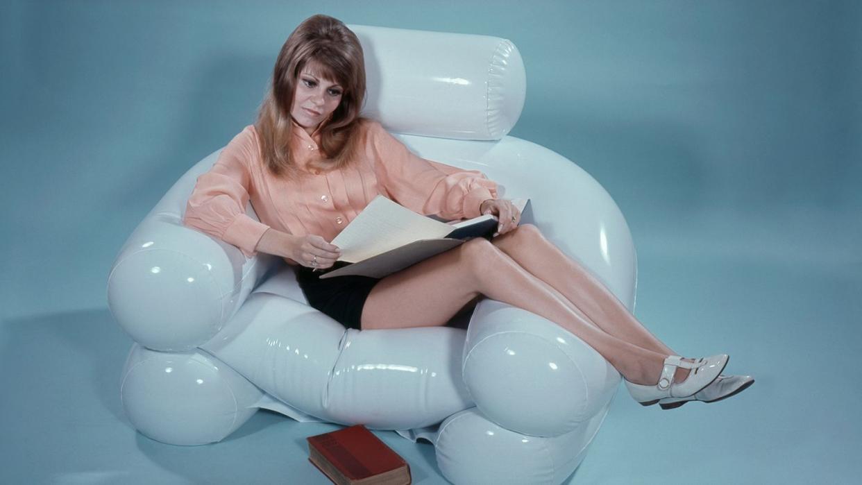 a woman sitting on a white chair