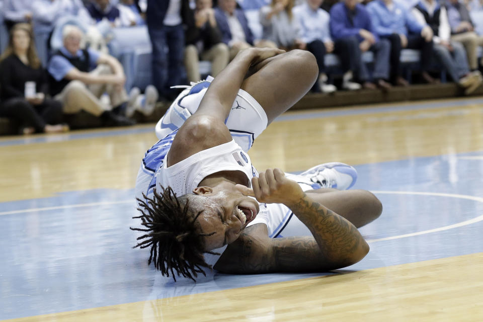 North Carolina forward Armando Bacot (5) grimaces in pain following an injury during the first half of an NCAA college basketball game against Ohio State in Chapel Hill, N.C., Wednesday, Dec. 4, 2019. (AP Photo/Gerry Broome)