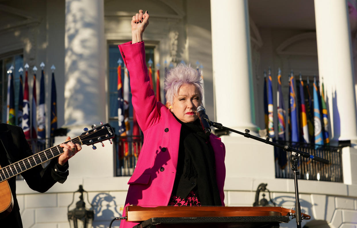 Musician Cyndi Lauper salutes the crowd as she performs at the signing ceremony for the Respect for Marriage Act.