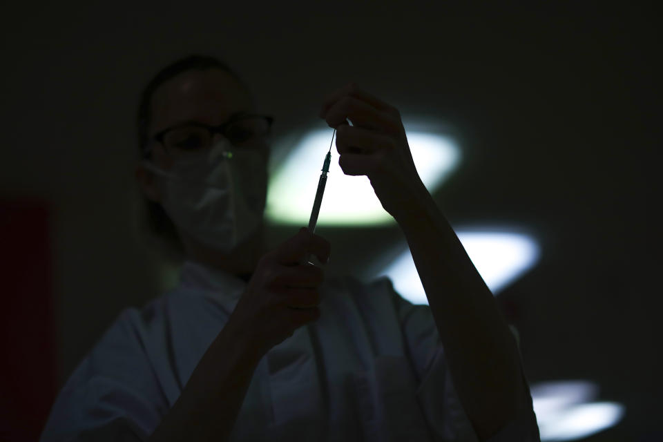 FILE - In this Dec. 28, 2020, file photo, a nurse prepares a syringe with the COVID-19 vaccine at La Bonne Maison de Bouzanton care home in Mons, Belgium. The global death toll from COVID-19 has topped 2 million. (AP Photo/Francisco Seco, Pool, File)