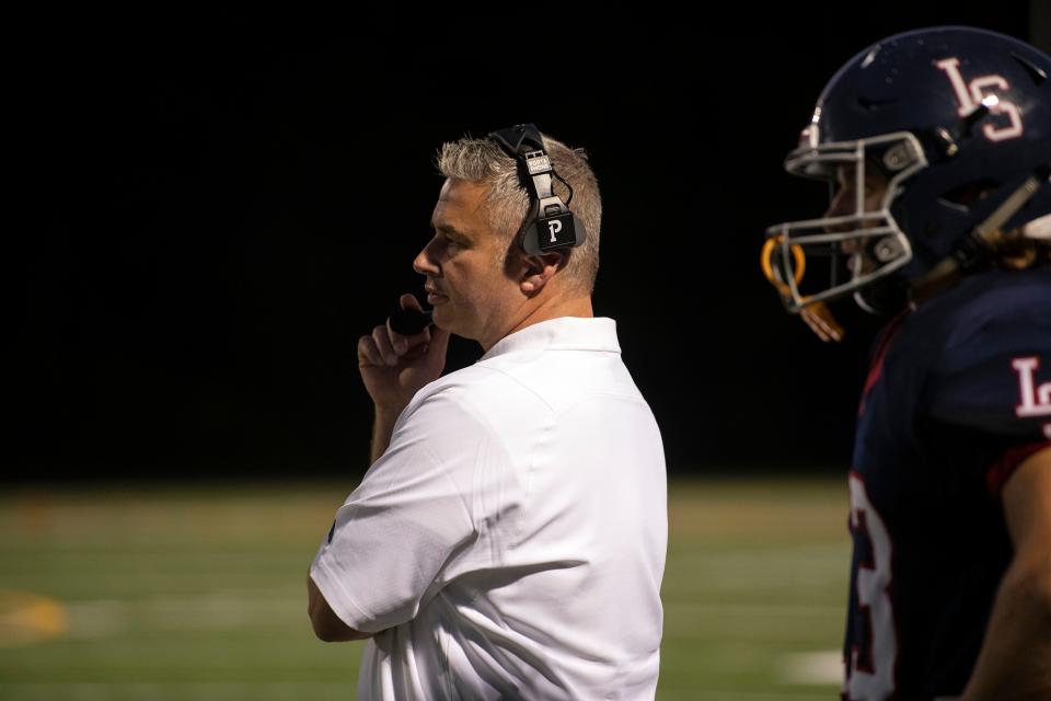 Lincoln-Sudbury head coach Jim Girard watches the action on the field during the season-opener against North Andover at Myers Field in Sudbury, Sept. 10, 2021. The Warriors defeated the Scarlet Knights, 48-20.