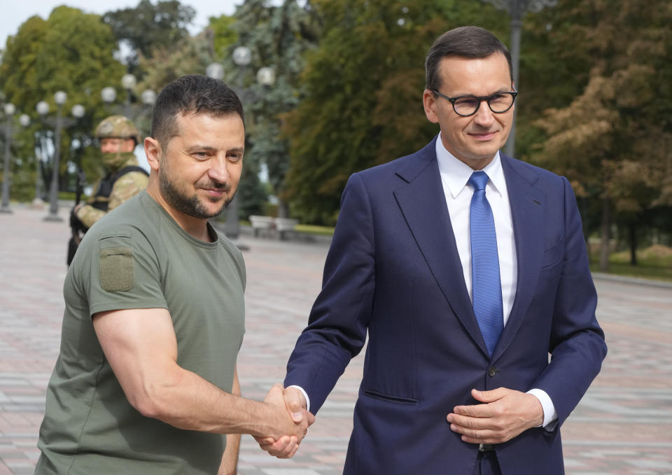 Ukrainian President Volodymyr Zelenskyy, left, and Poland's Prime Minister Mateusz Morawiecki shake hands during their meeting in Kyiv, Ukraine, Friday, Sept. 9, 2022. (AP Photo/Efrem Lukatsky)